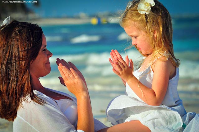 mom and daughter play patty cake