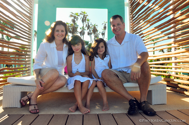 family sitting for portrait in cancun mexico