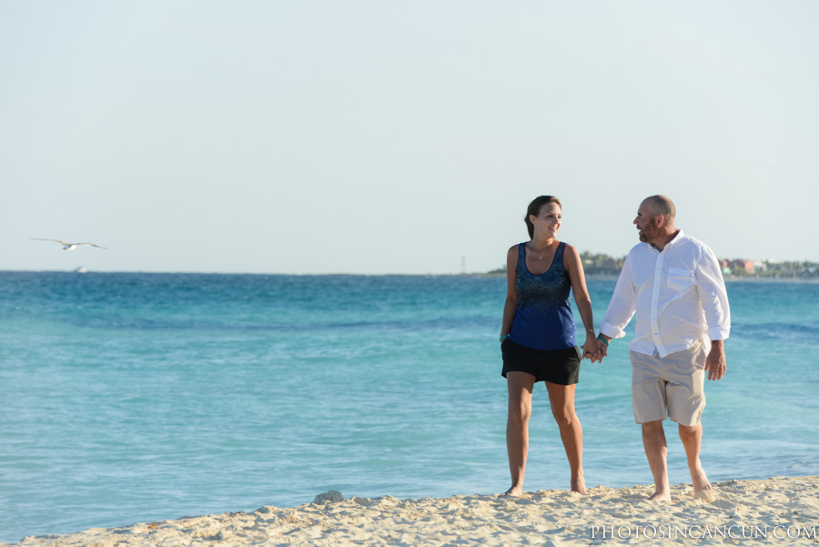 Couple walking along beach in Cancun Mexico