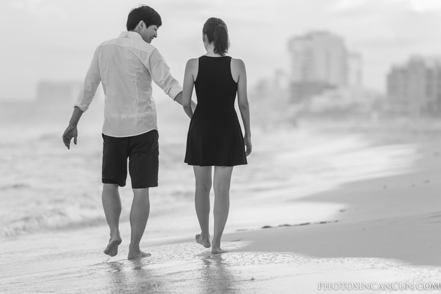 Black and White of couple walking along the beach