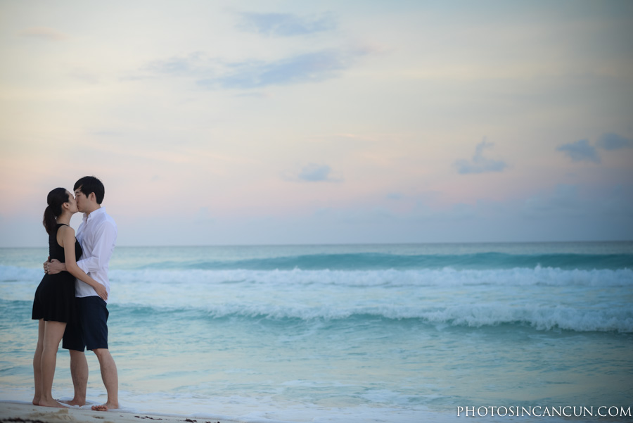 A couple kissing along the beach in Cancun Mexico